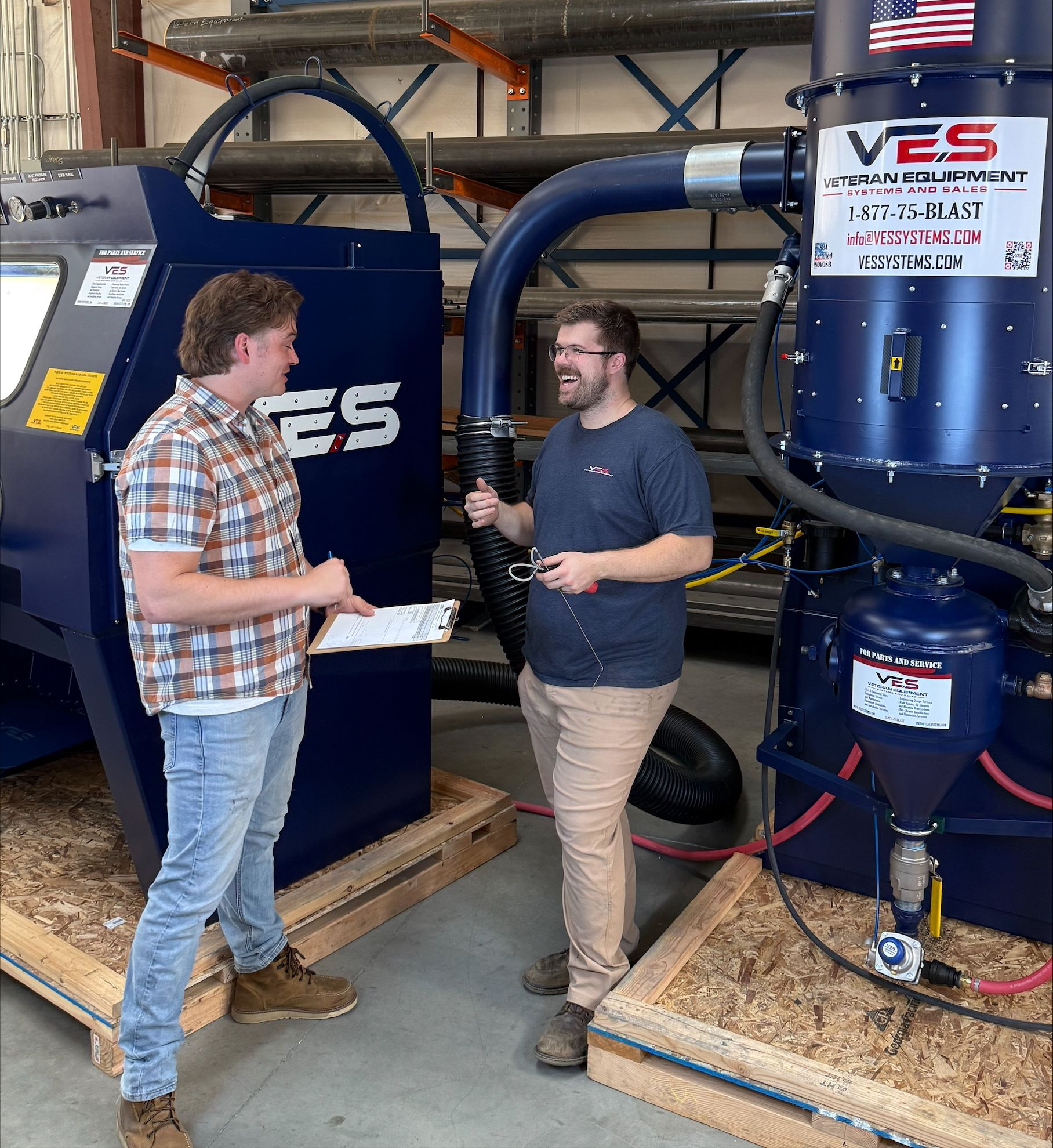 Two VES engineers discussing VES blasting equipment.