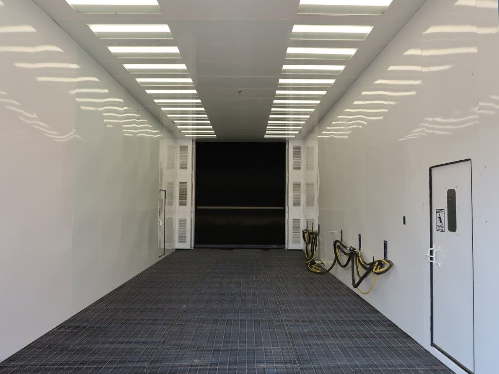 White VES blast booth interior with LED lighting.