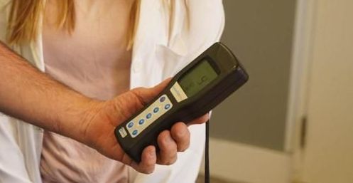 A woman is holding a remote control in her hands.