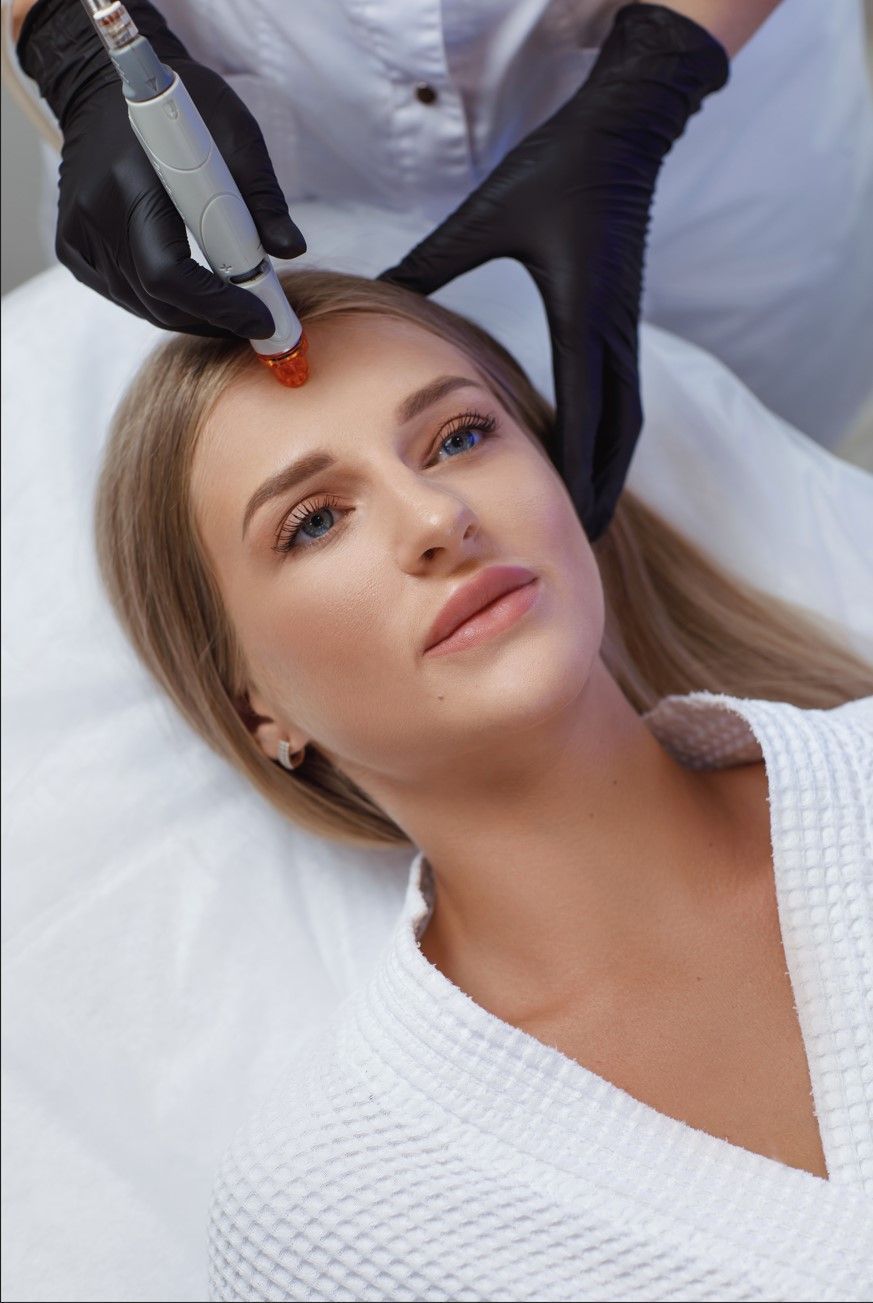 A woman is getting a facial treatment at a beauty salon.
