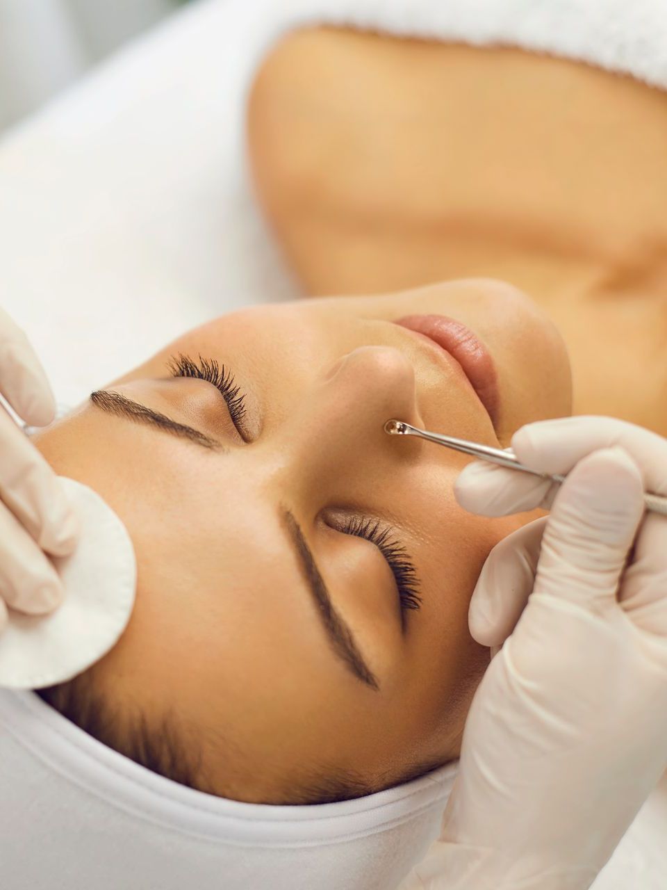 A woman is getting a facial treatment at a spa.