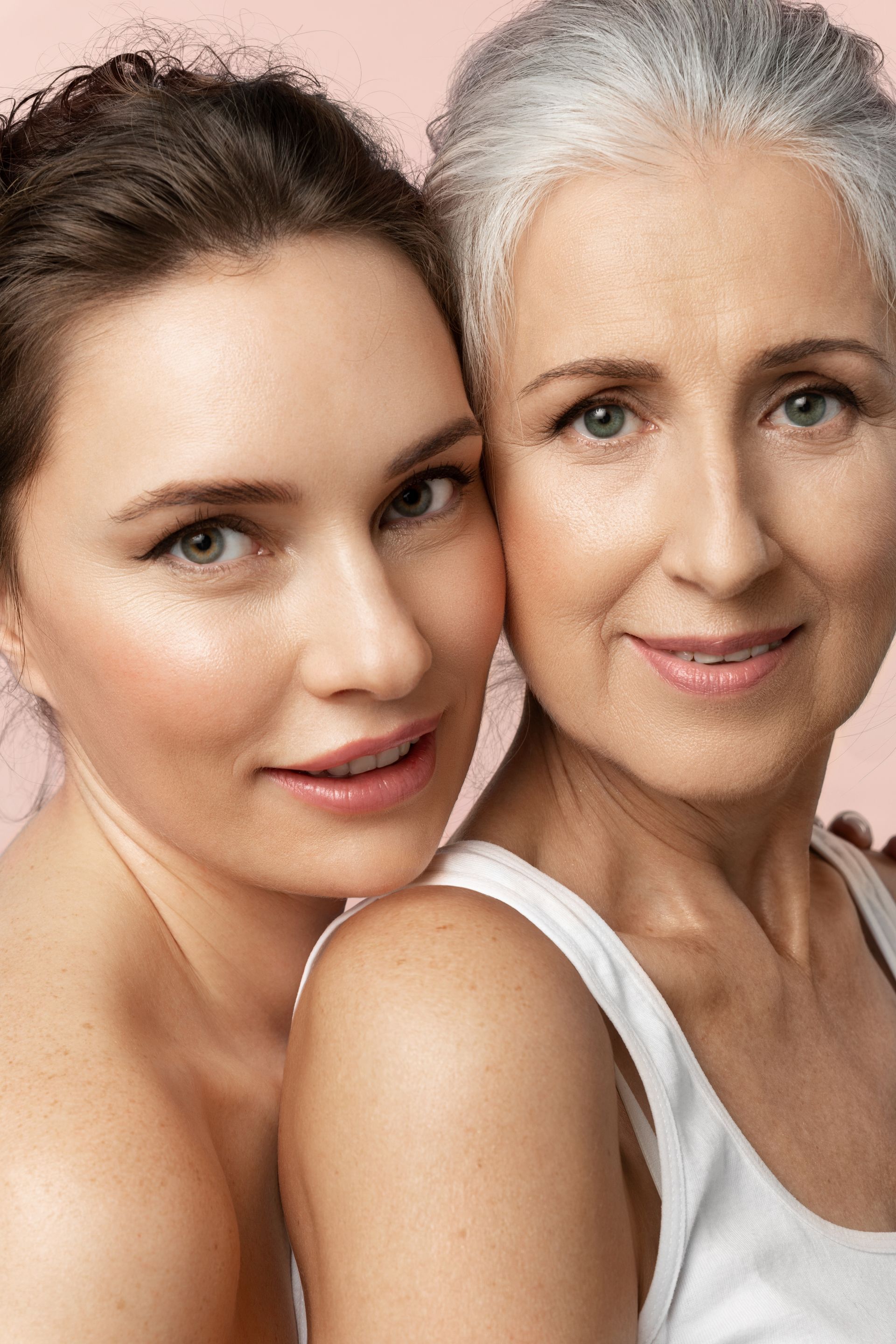 A young woman and an older woman are posing for a picture.