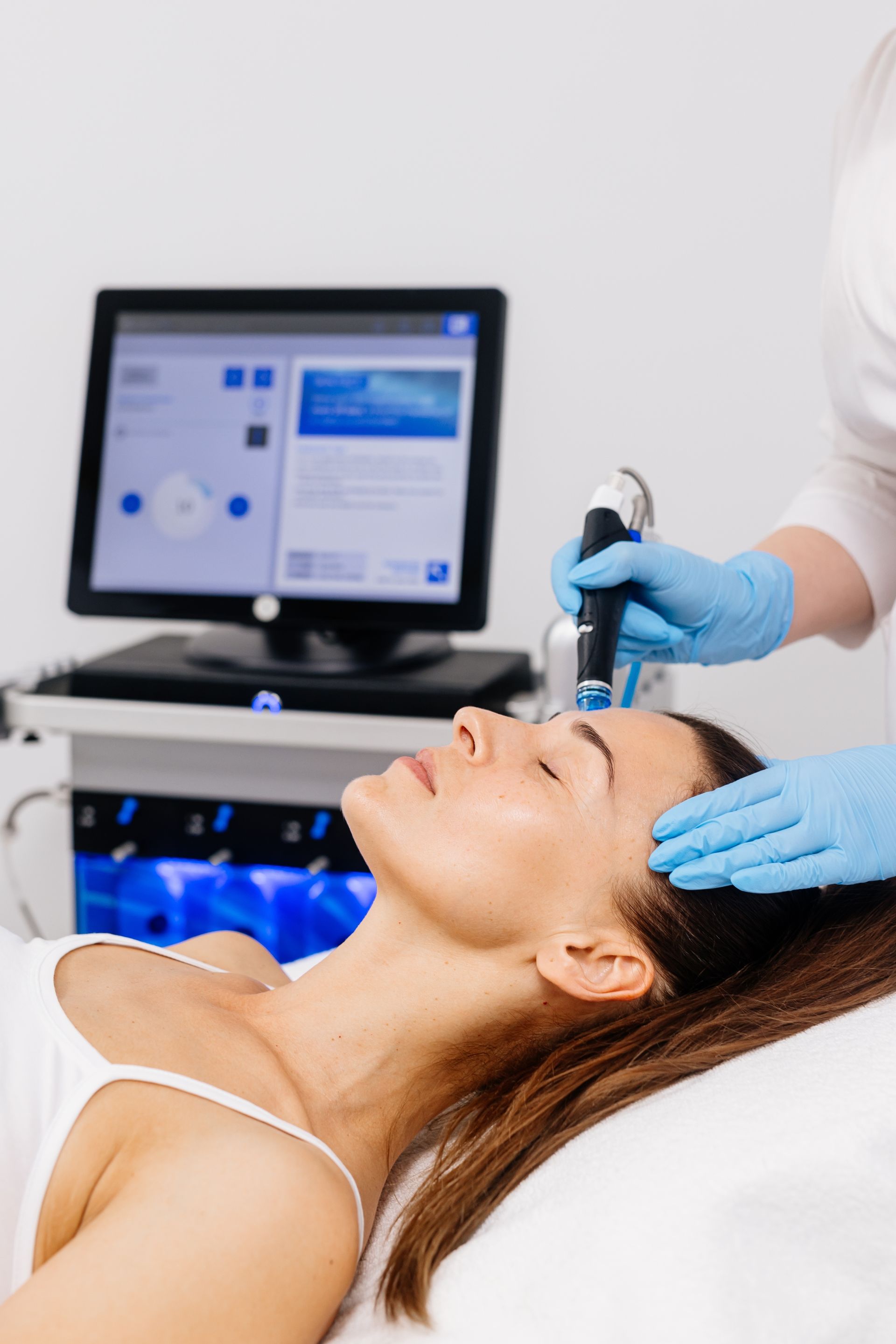 A woman is getting a botox injection in her face.