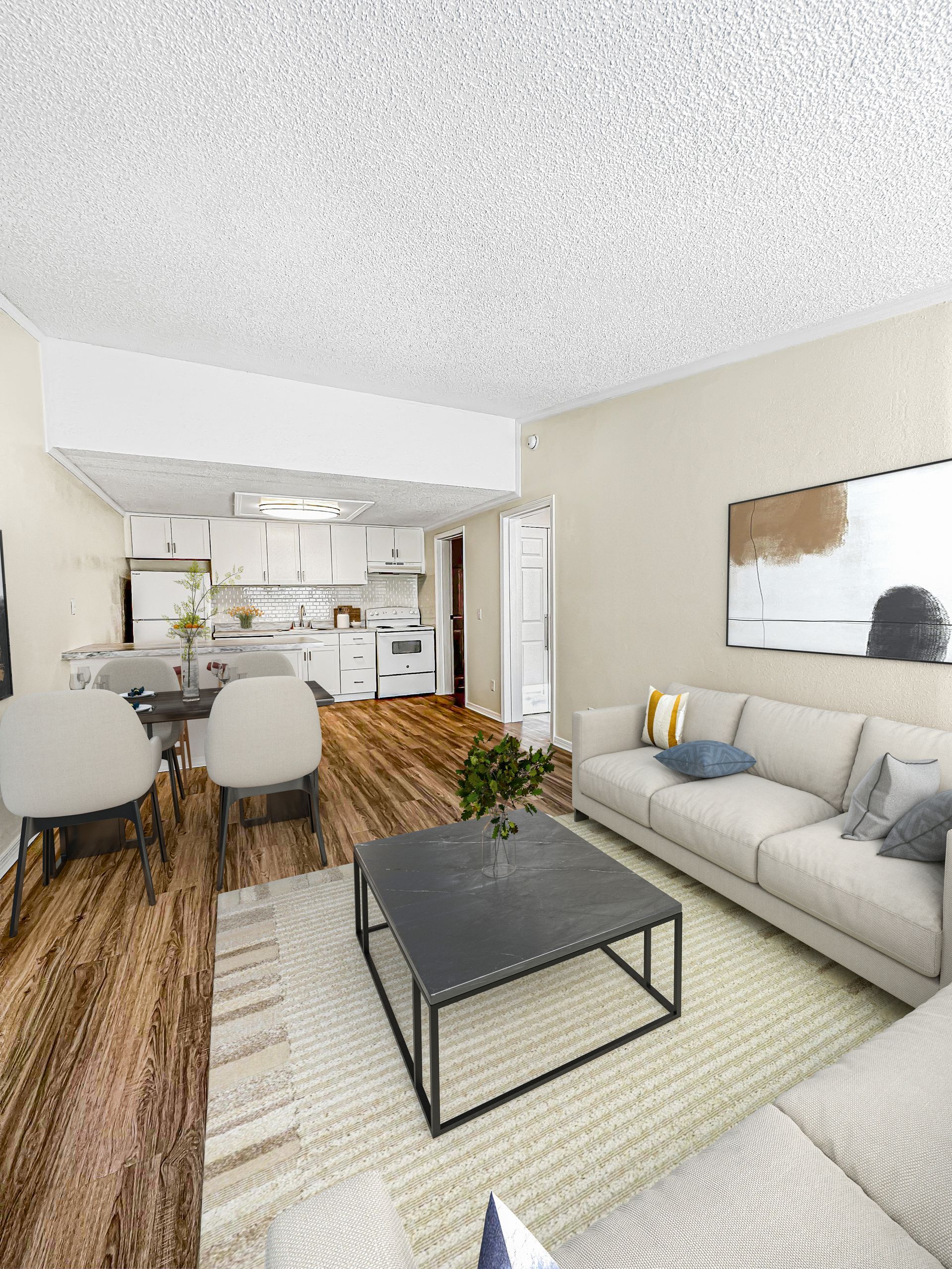 Photo of a living room, looking into the dining and kitchen area