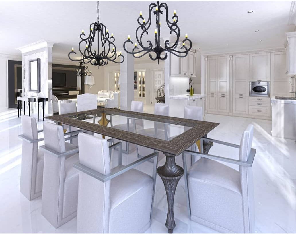 Bright white dining room with a glass table, white chairs, and ornate black chandeliers.