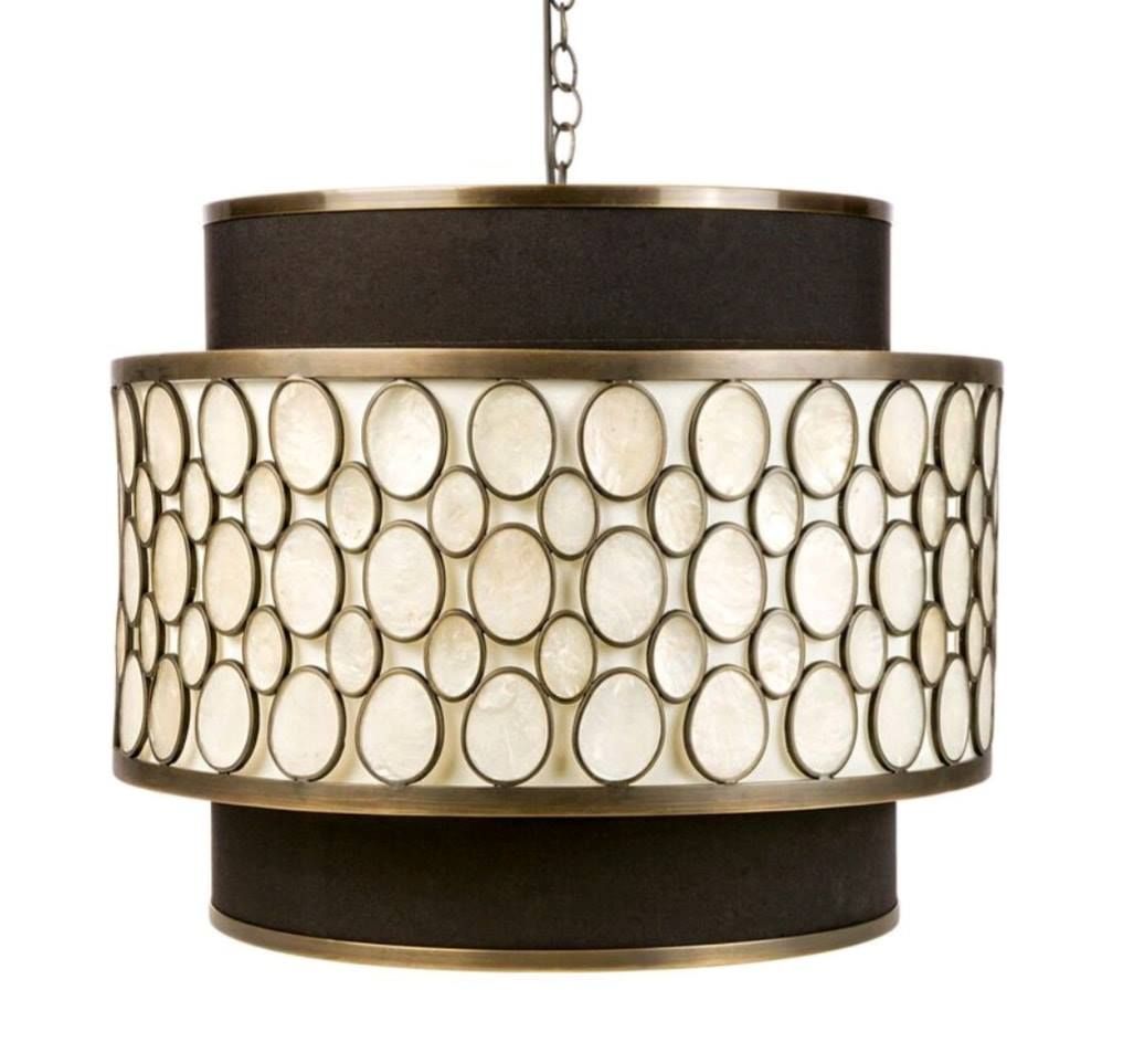 Round cream pendant light with dark brown trim and circular patterned shade