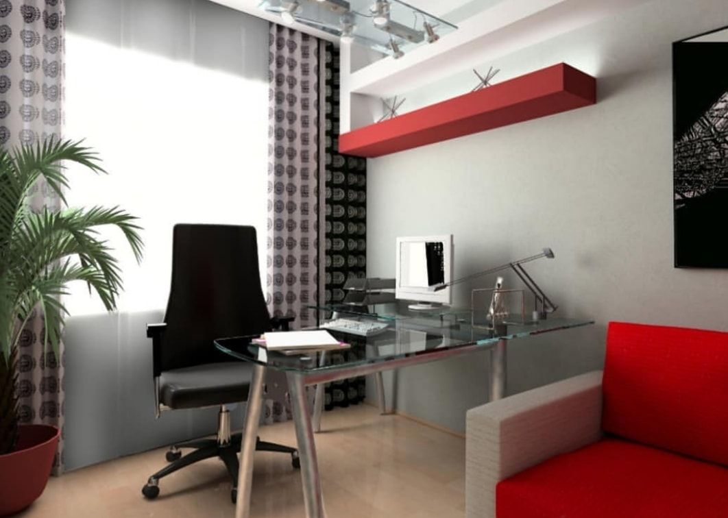 Modern home office with glass desk, black chair, red sofa, and white walls
