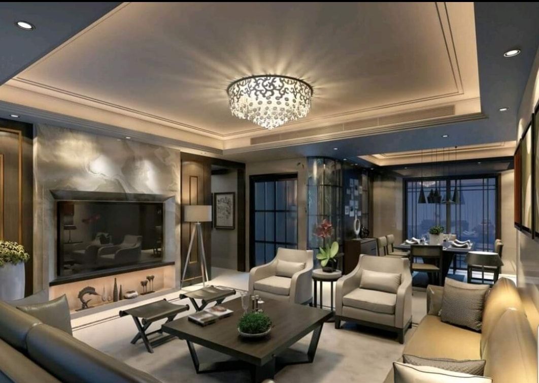 Elegant living room with chandelier, fireplace, TV, and white armchairs in a modern luxury interior