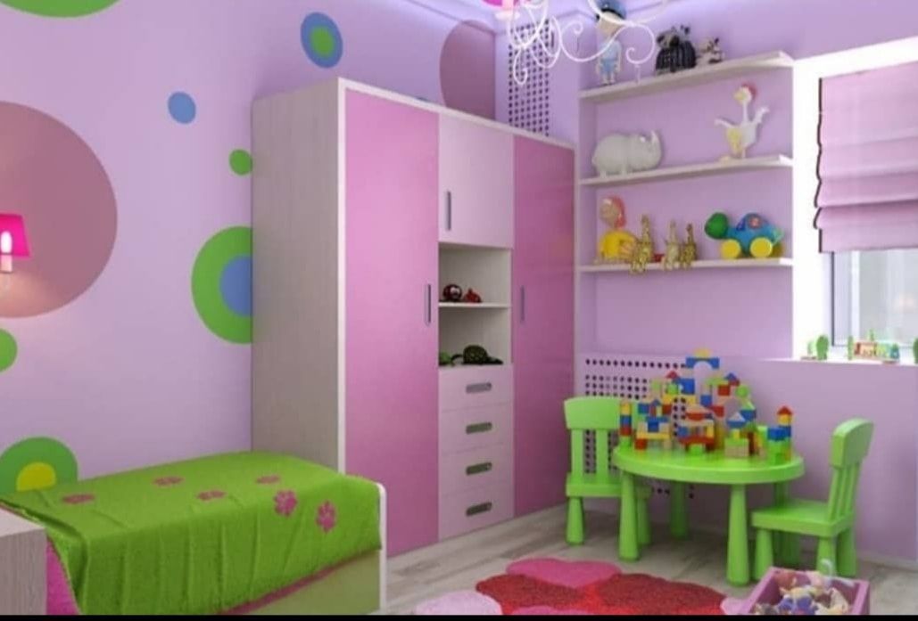 Pink children's bedroom with green furniture, polka-dot wall, bunk bed, and a small play table with toys