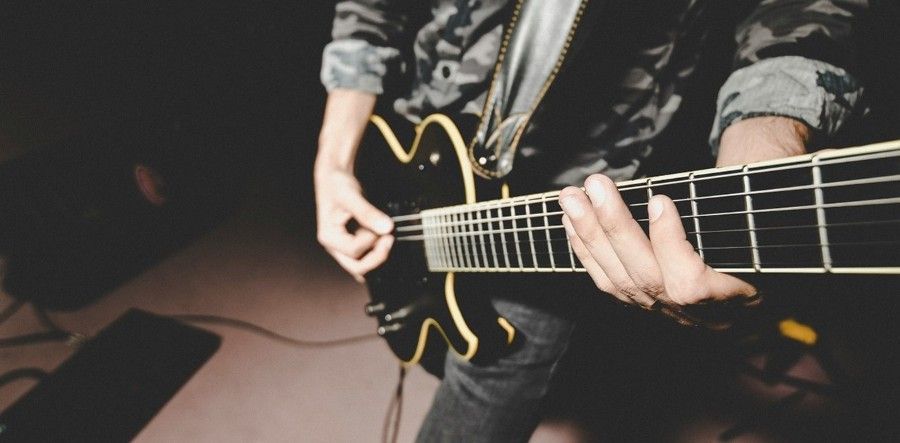 person playing electric guitar