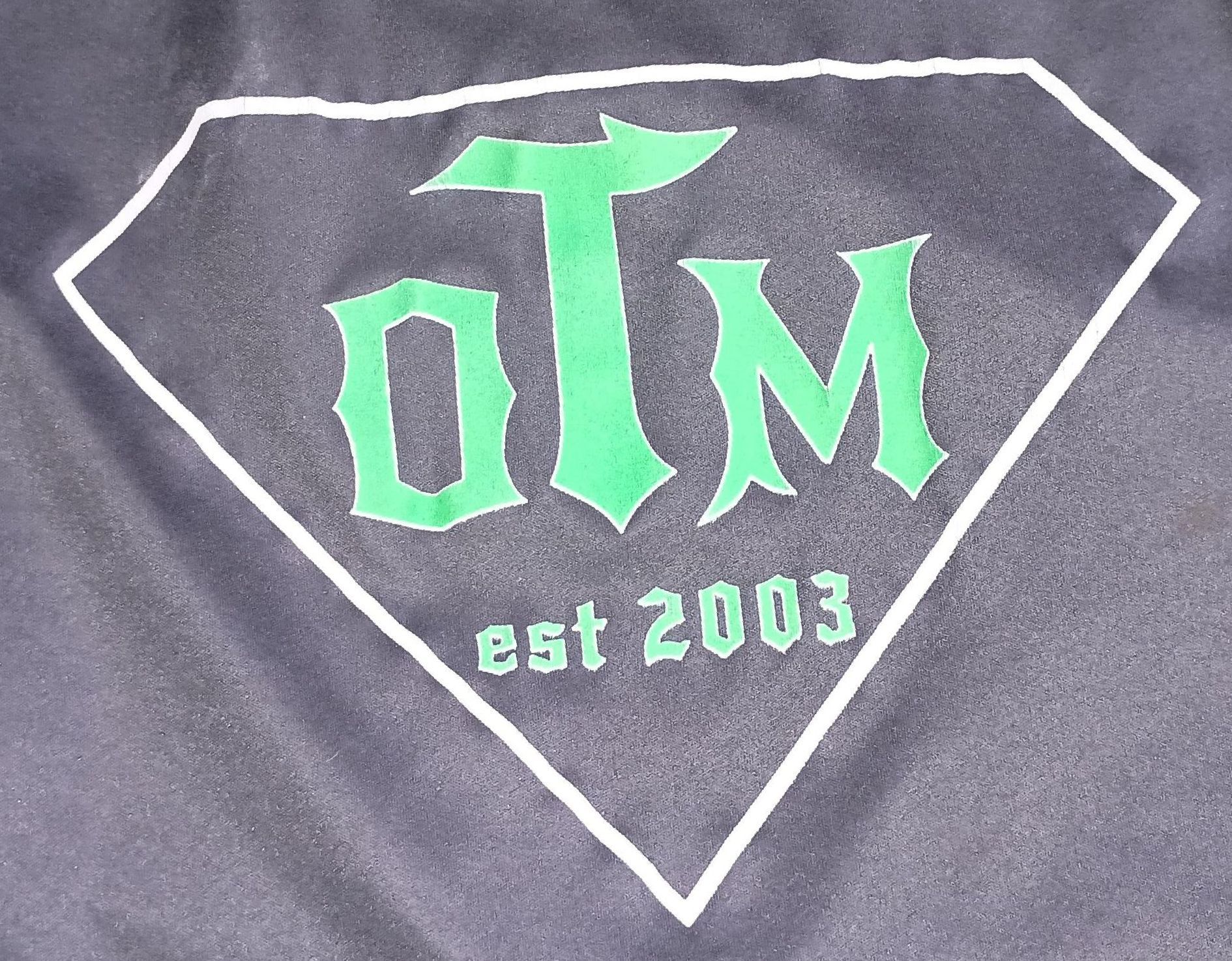 A black shirt with the word olm on it