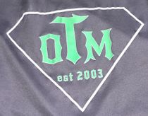 A black shirt with the word olm on it