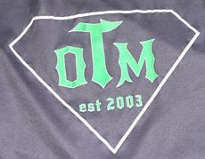 A black shirt with the word olm on it