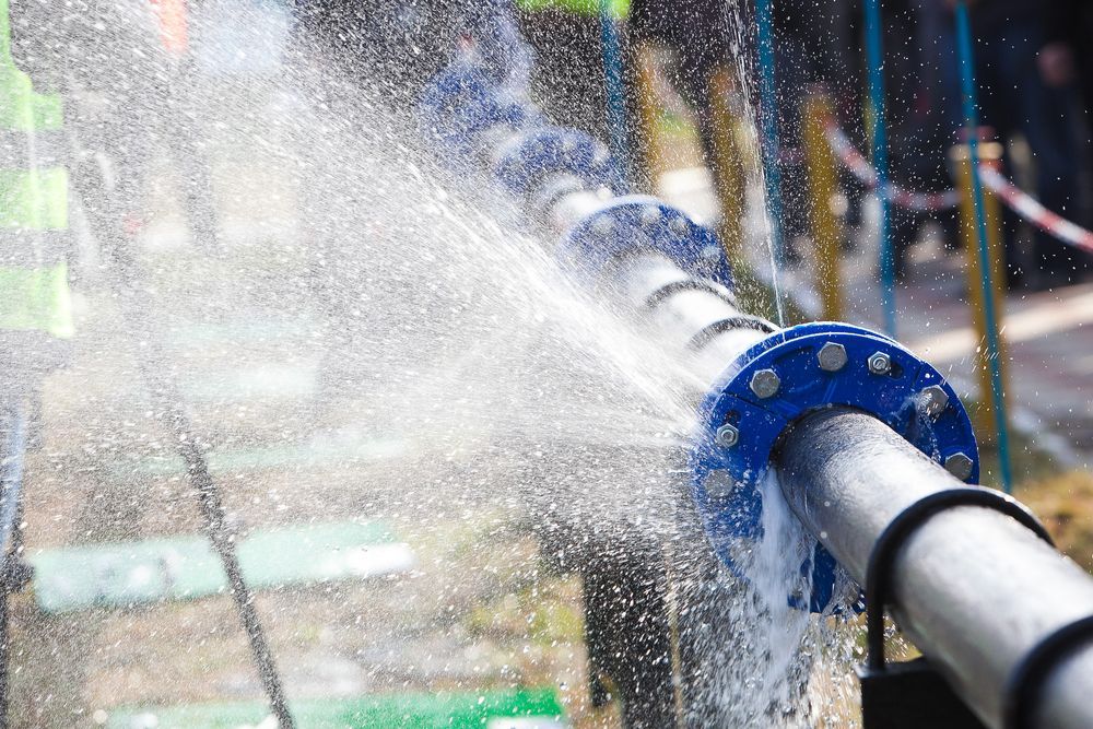 Water Gushing From a Damaged Metal Pipe — Waves Plumbing in Gosford, NSW