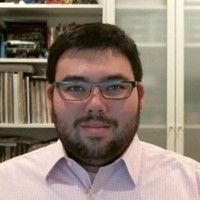 An image of the Pastor, Chris Tanimura. He is looking directly forward, with glasses and a beard.