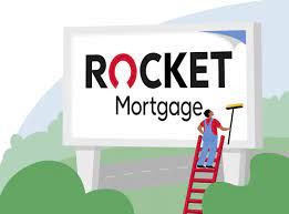 Rocket Mortgage billboard being cleaned by a person on a red ladder.