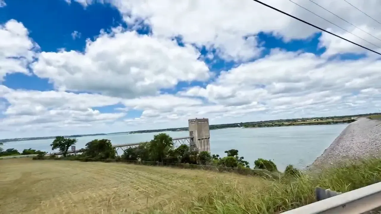 Lake overlook with stone pillars railing and expansive water view