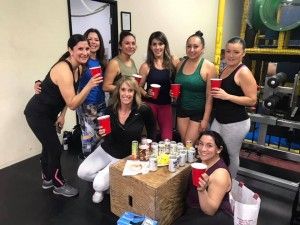 A group of women are posing for a picture in a gym.