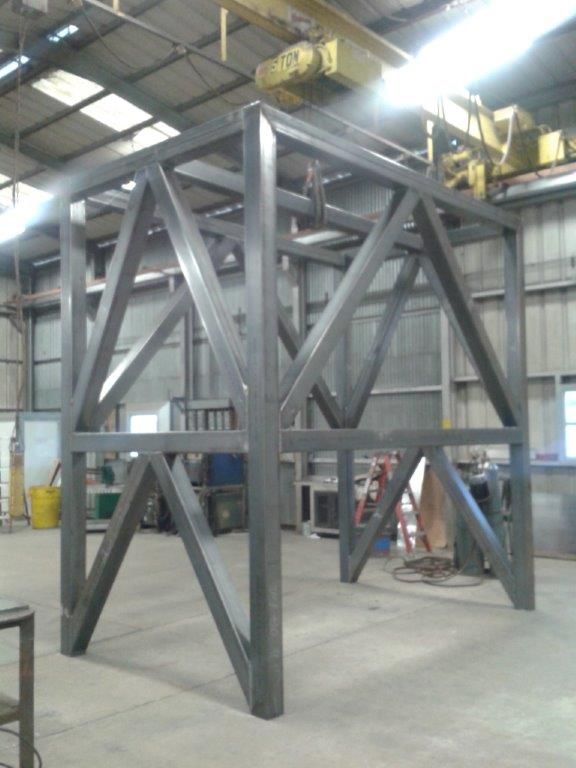 Welded steel frame structure in a workshop.