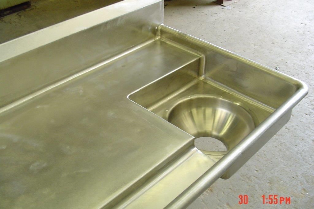 Stainless steel autopsy table with sink.