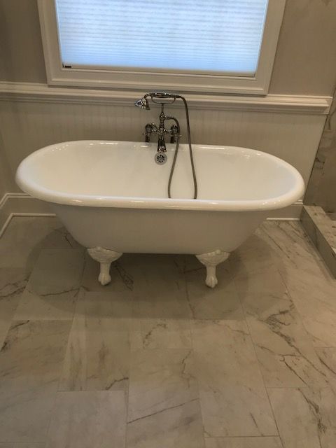 A White Bathtub Is Sitting in A Bathroom Next to A Window | Tonao, VA | Don Kendrick