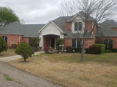 Large Brick House With a Gray Roof