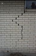 Cracked gray brick wall