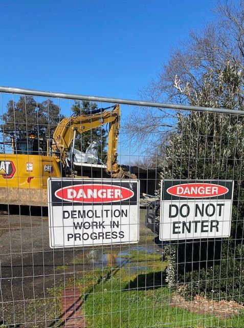 A fence with a danger sign and a do not enter sign