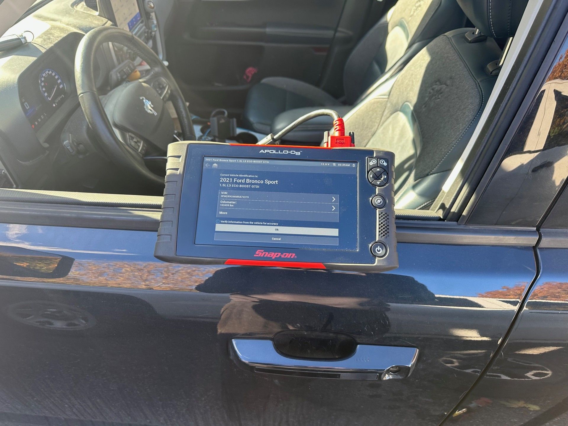 Diagnostic tool on a car door, connected to the interior | Campbell’s Fix All LTD
