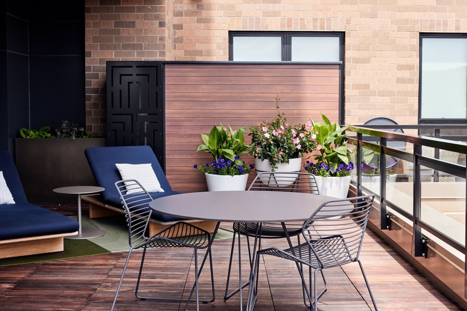 2nd-level patio with chaise lounges and cafe tables