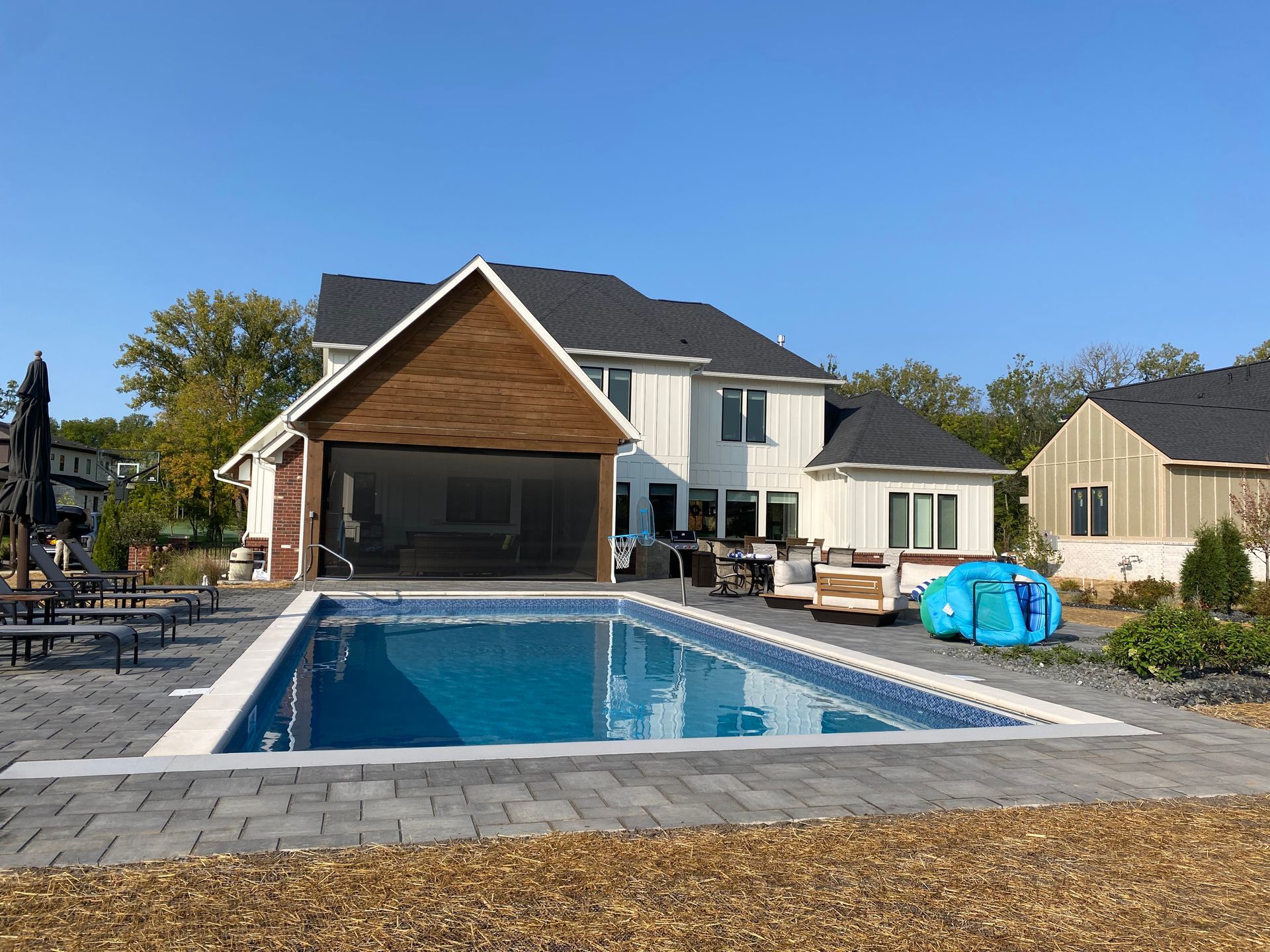 A large swimming pool with a shed in the background