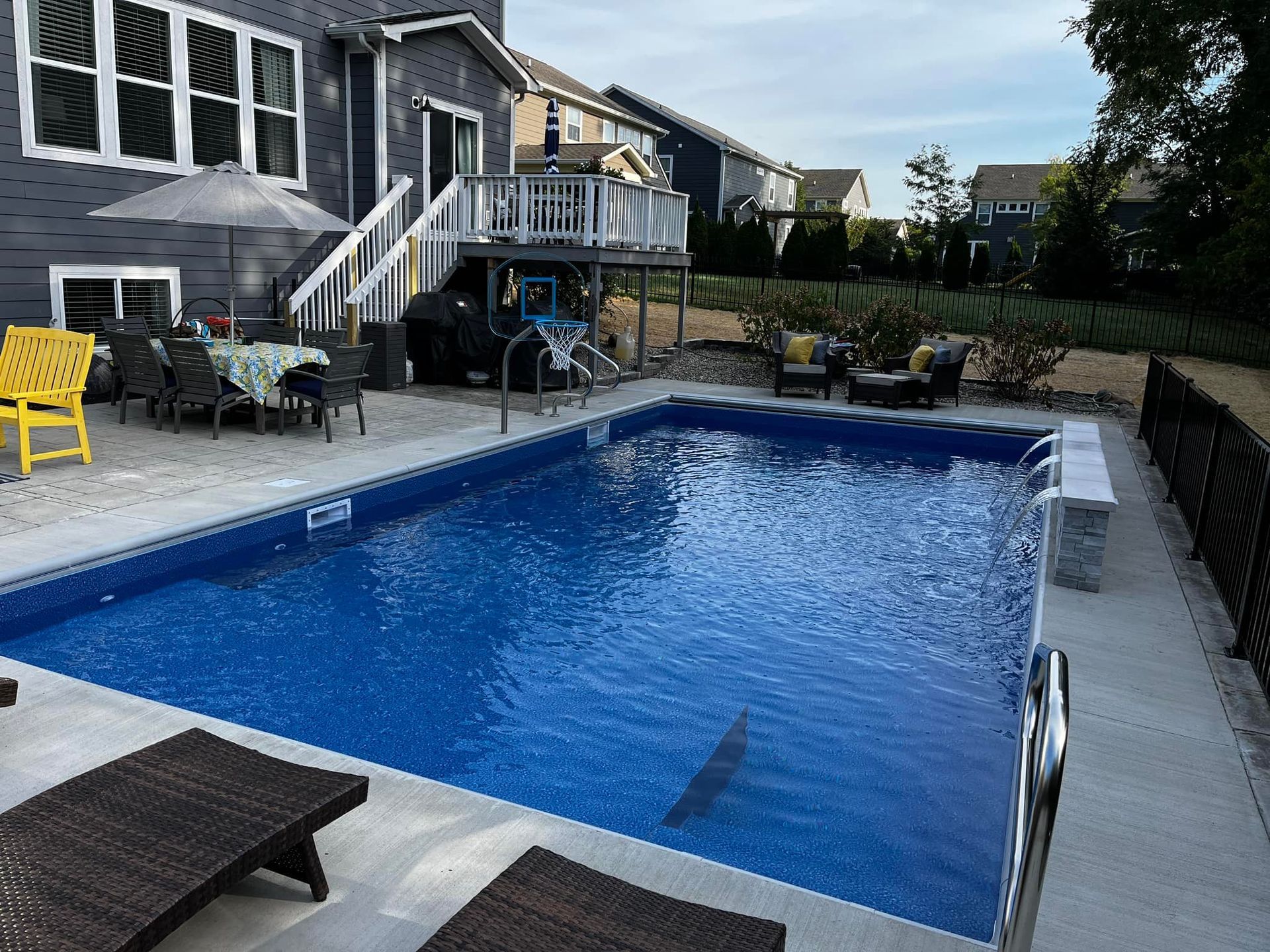 A large swimming pool in front of a house