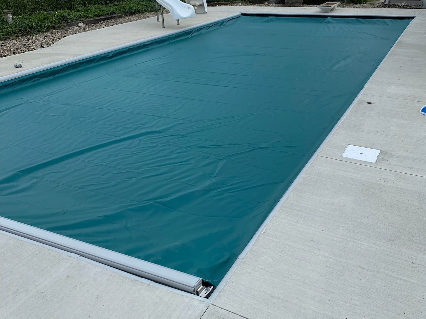 A swimming pool is lit up with blue lights at night