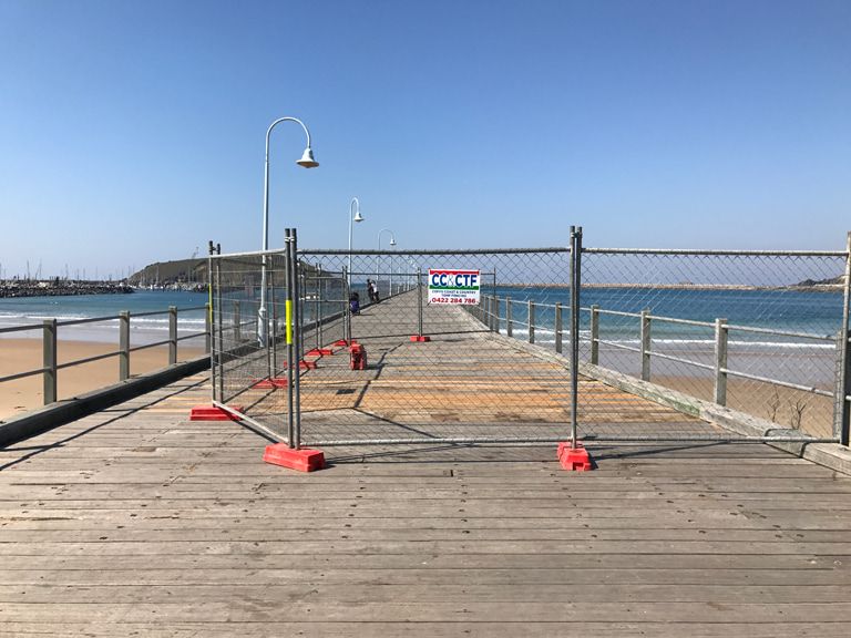 A Pier With Temporary Fence Around It — Coffs Coast and Country Temp Fence in Sapphire Beach, NSW