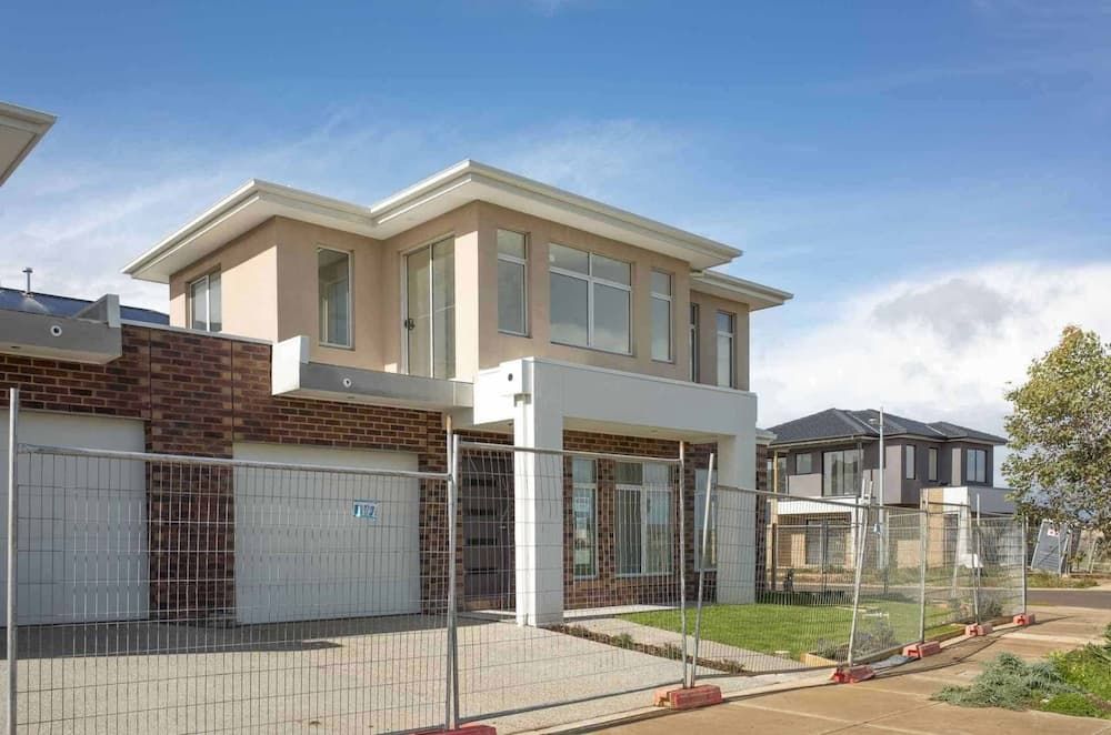 A House That is Being Built With a Temporary Fence Around It — Coffs Coast and Country Temp Fence in Sapphire Beach, NSW