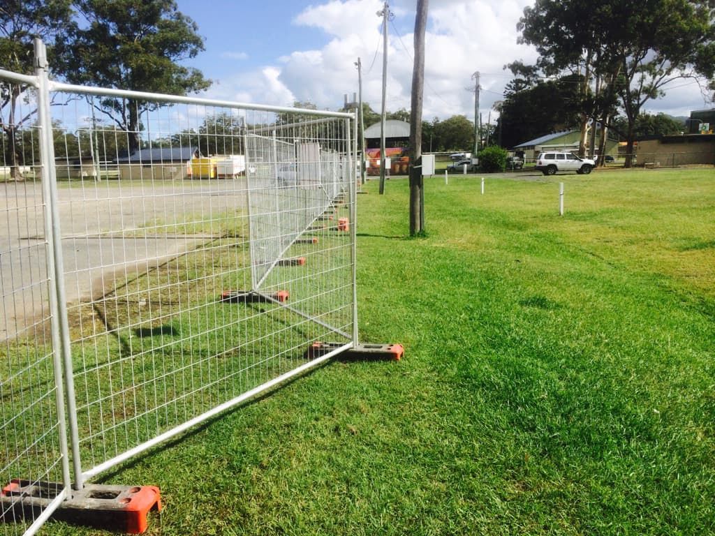 A Fence is Sitting in the Middle of a Grassy Field — Coffs Coast and Country Temp Fence in Sapphire Beach, NSW