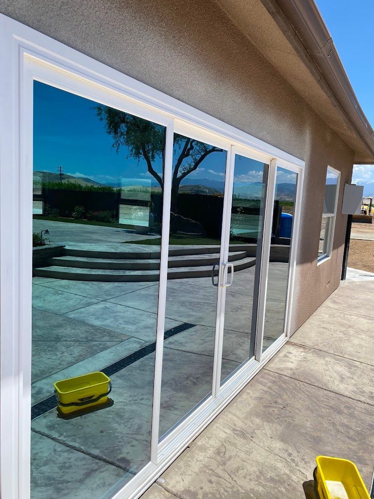 A house with a lot of windows and a reflection of a tree in the windows.