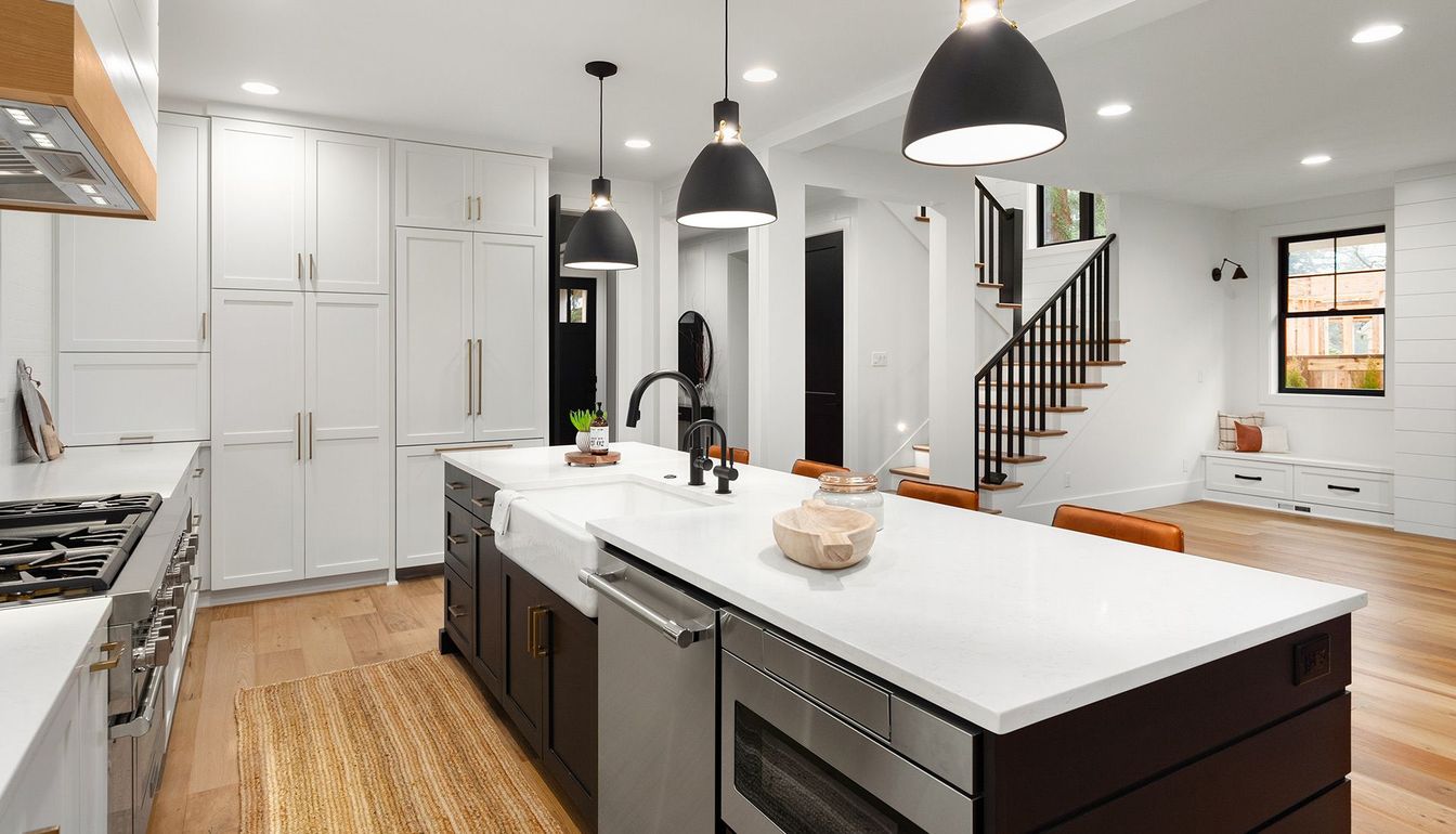 A kitchen with stainless steel appliances and a large island.