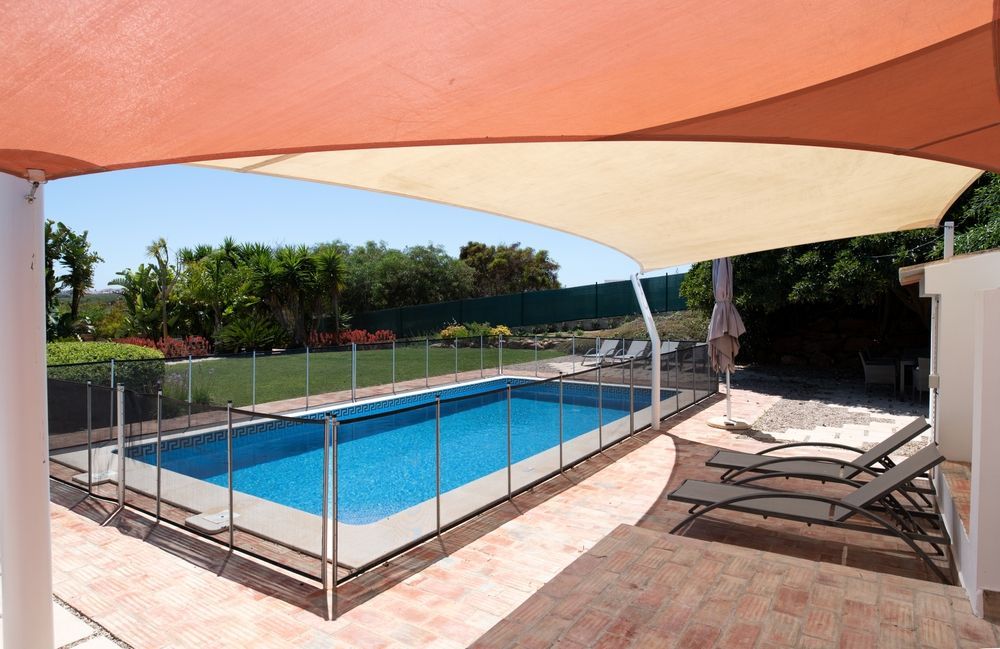 A Rectangular Swimming Pool Surrounded by a Glass Fence — Get My Pool Certified in Broadbeach Waters, QLD
