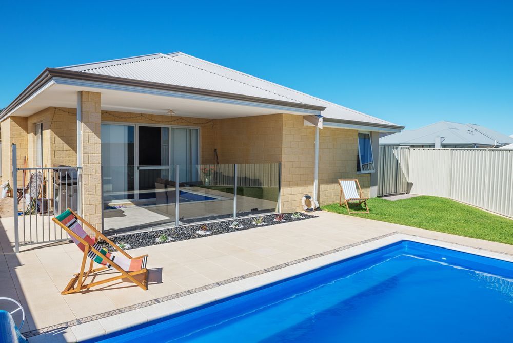 A Backyard With a Rectangular Blue Swimming Pool — Get My Pool Certified in Burleigh Heads, QLD
