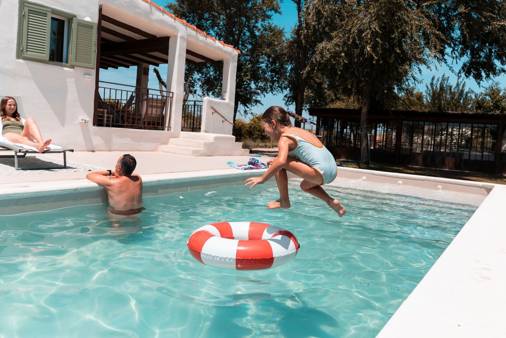 A Person Jumps Into a Sunny Backyard Pool — Get My Pool Certified in Burleigh Heads, QLD