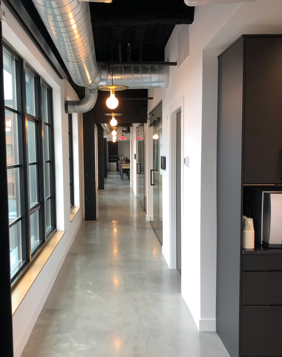 A long hallway in a building with a lot of windows