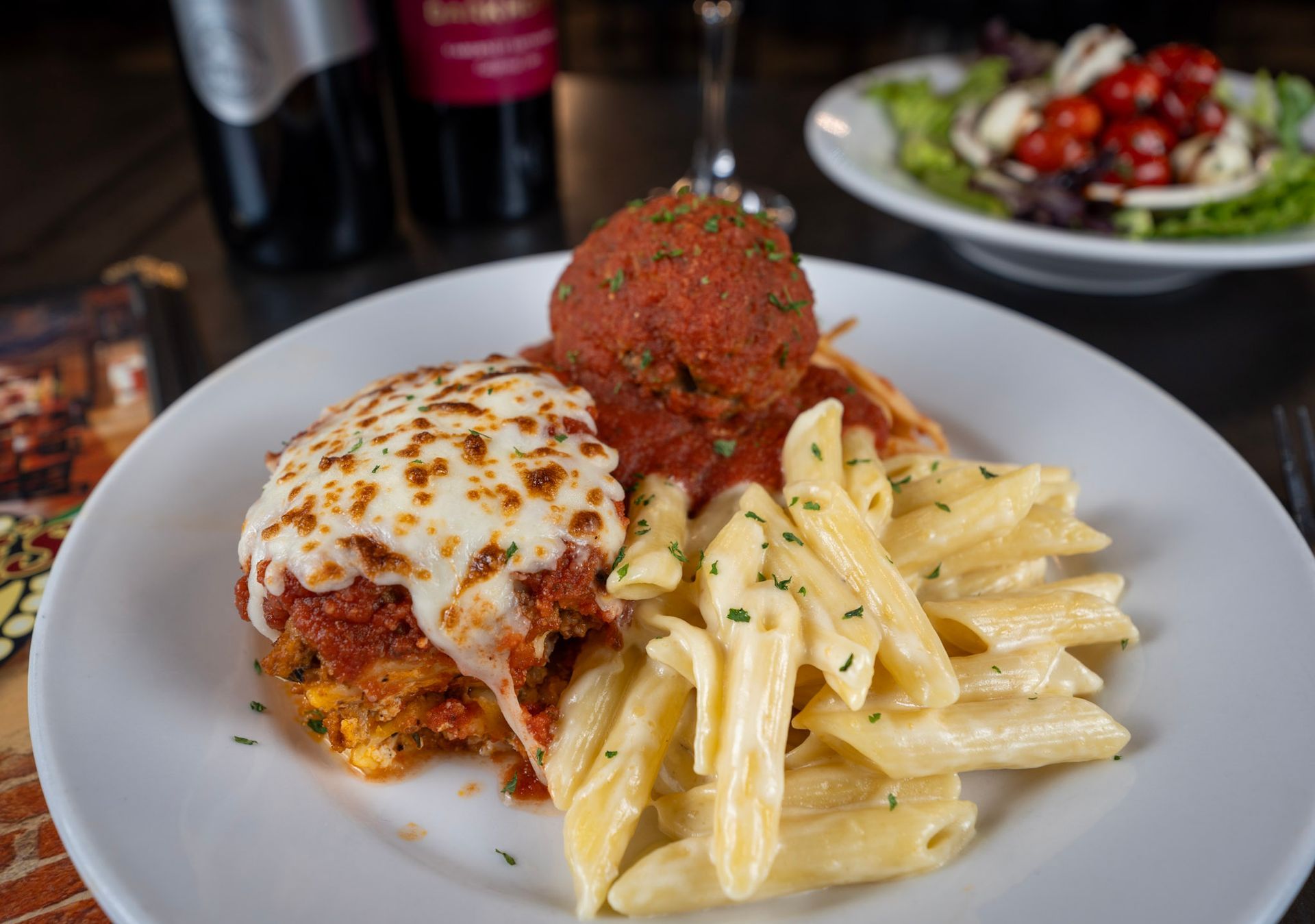 A plate of food with pasta and meatballs on a table.