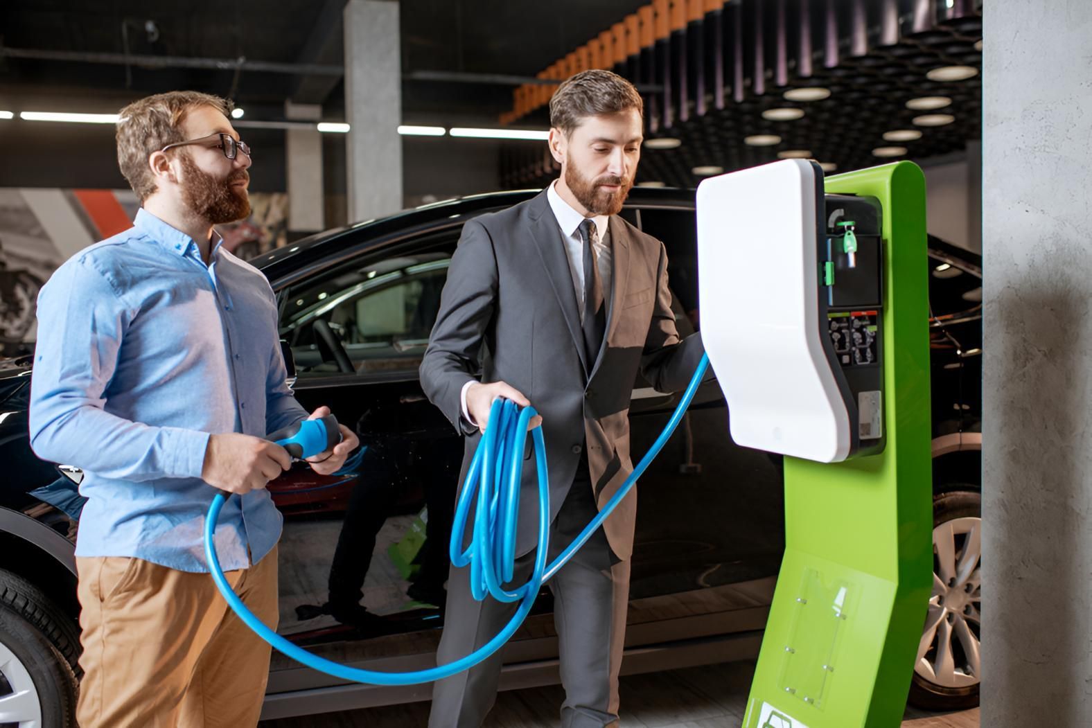 Two Men Are Charging An Electric Car — Stanger Automatics In Ballina, NSW