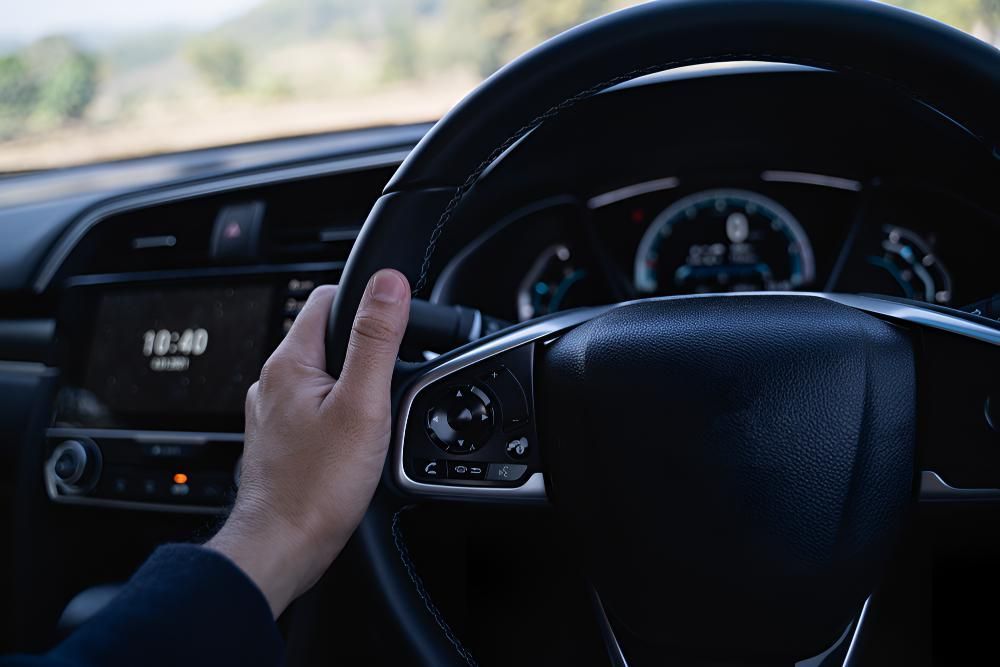 A Person Is Holding The Steering Wheel — Stanger Automatics In Ballina, NSW
