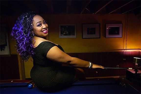 Image contains woman, pool table, cue stick, wall frames