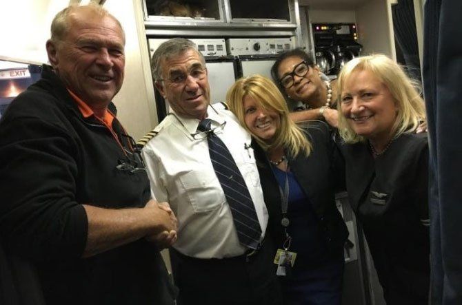 Image may contain men, women, glasses, pilot, airplane interior