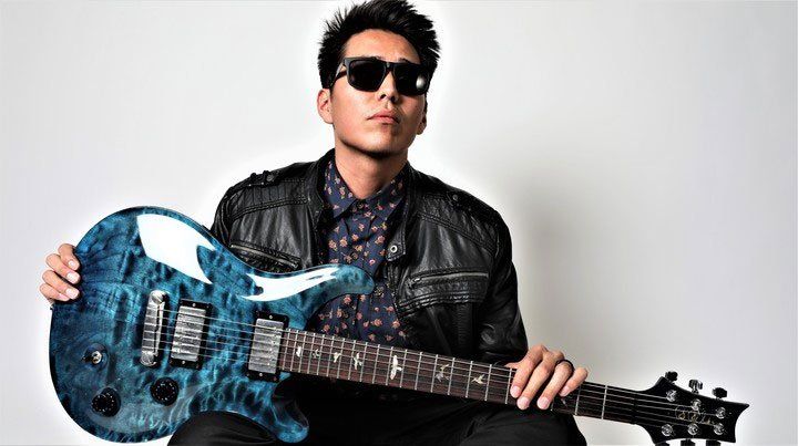 Image may contain guitar, man, sunglasses