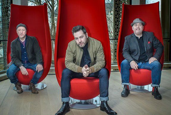 Image may contain seated men, red chairs