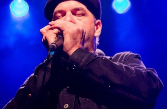 Image may contain man, microphone, beret